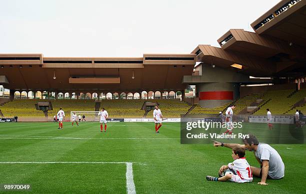 Jarno Trulli of Italy and Lotus is pictured with his son ahead the football charity match between the Monaco star team and the team of formula one...