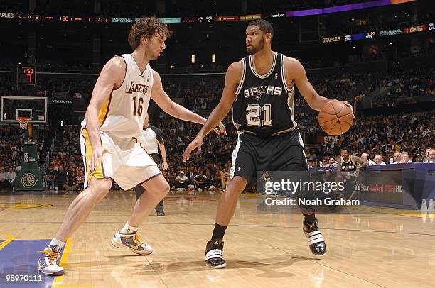 Tim Duncan of the San Antonio Spurs dribble the ball against Pau Gasol of the Los Angeles Lakers at Staples Center on April 4, 2010 in Los Angeles,...