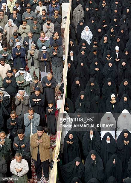 Iraqi Shiite women and men are separated as they perform perform Friday noon prayer at Imam al-Hussein shrine in the holy city of Karbala, 10...