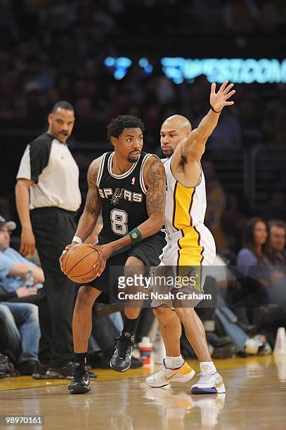 Roger Mason Jr. #8 of the San Antonio Spurs moves the ball against Derek Fisher of the Los Angeles Lakers at Staples Center on April 4, 2010 in Los...