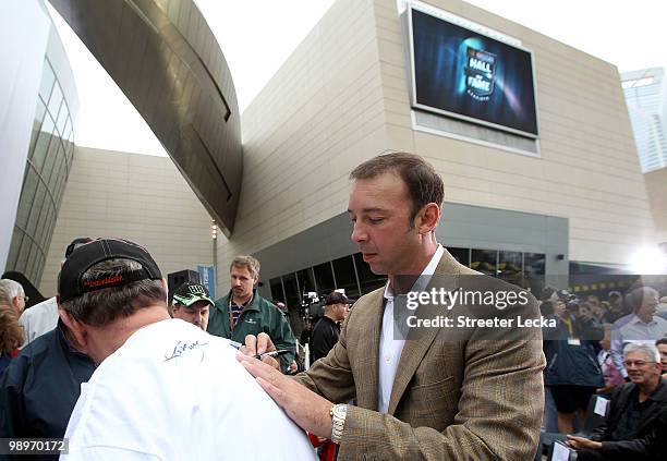 Chad Knaus, crew chief of the Lowe's Chevrolet, signs autographs during the NASCAR Hall of Fame Grand Opening at the NASCAR Hall of Fame on May 11,...