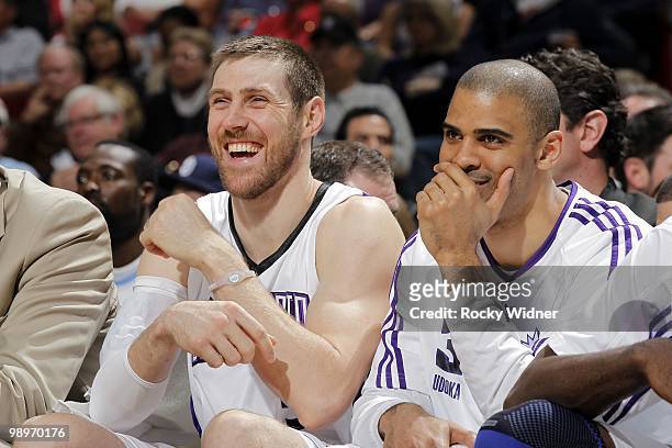 Andres Nocioni and Ime Udoka of the Sacramento Kings share a laugh on the bench during the game against the Dallas Mavericks at Arco Arena on April...
