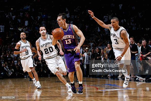 Steve Nash of the Phoenix Suns drives up court followed by Tony Parker, Manu Ginobili and George Hill of the San Antonio Spurs in Game Four of the...