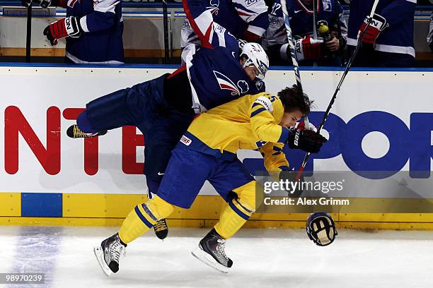 Erik Karlsson of Sweden is challenged by Kevin Hecquefeuille of France during the IIHF World Championship group C match between Sweden and France at...