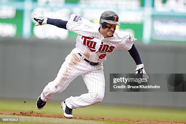 Nick Punto of the Minnesota Twins dives back to first base to avoid getting picked off by the Baltimore Orioles on May 8, 2010 at Target Field in...