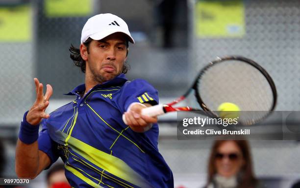 Fernando Verdasco of Spain plays a forehand against Ivo Karlovic of Croatia in their second round match during the Mutua Madrilena Madrid Open tennis...