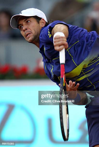 Fernando Verdasco of Spain serves against Ivo Karlovic of Croatia in their second round match during the Mutua Madrilena Madrid Open tennis...