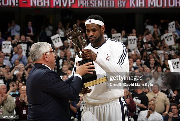 Commissioner David Stern presents LeBron James of the Cleveland Cavaliers with his Maurice Podoloff Trophy in recognition for being named the 2009-10...