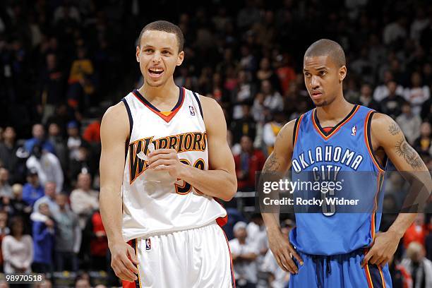 Stephen Curry of the Golden State Warriors and Eric Maynor of the Oklahoma City Thunder stand on the court during the game at Oracle Arena on April...