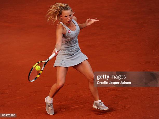 Caroline Wozniacki of Denmark plays the ball to Alona Bondarenko of Ukraine in her first round match during the Mutua Madrilena Madrid Open tennis...