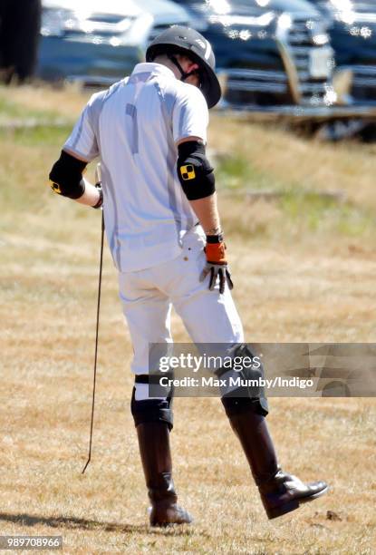 Prince Harry, Duke of Sussex stretches before taking part in the Audi Polo Challenge at Coworth Park Polo Club on June 30, 2018 in Ascot, England.