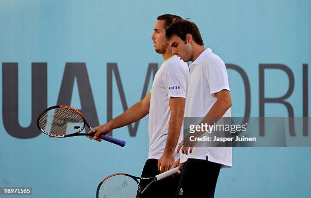 Marcel Granollers of Spain chats with his doubles partner Viktor Troicki of Serbia in their first round match against Andy Roddick of the USA and...