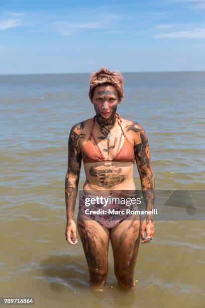 serious woman standing in water - saint simons island stockfoto's en -beelden