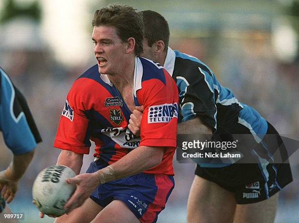 Matt Gidley of the Knights looks to offload during the round 22 NRL match between the Sharks and the Newcastle Knights held at Toyota Park, Sydney,...