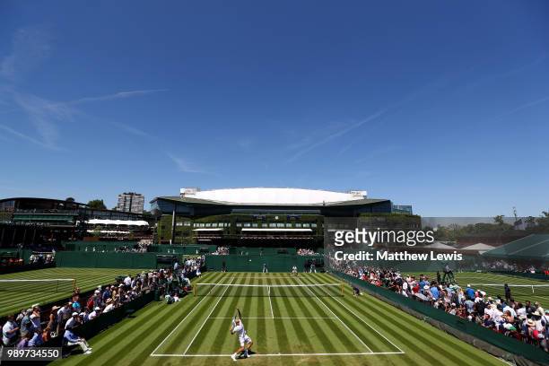 Sergiy Stakhovsky of Ukraine plays against Joao Sousa of Portugal during their Men's Singles first round match on day one of the Wimbledon Lawn...