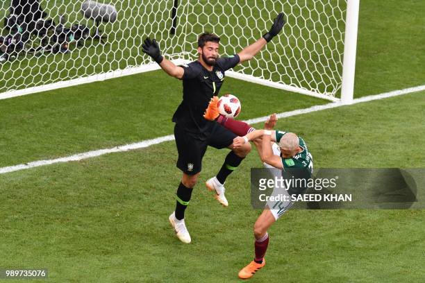 Mexico's forward Javier Hernandez vies for the ball with Brazil's goalkeeper Alisson during the Russia 2018 World Cup round of 16 football match...