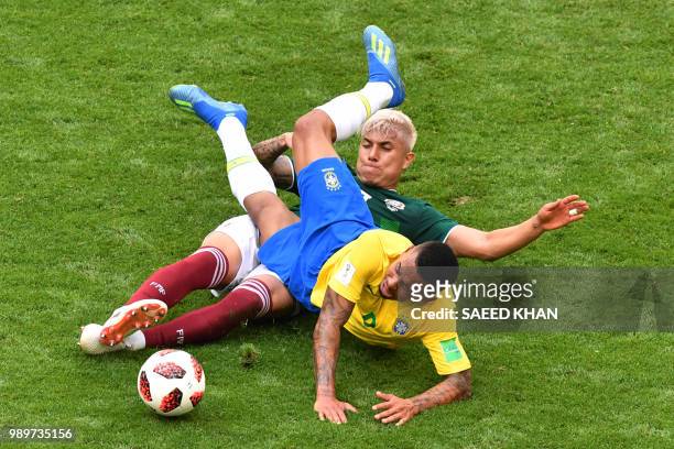 Brazil's forward Gabriel Jesus is tackled by Mexico's defender Carlos Salcedo during the Russia 2018 World Cup round of 16 football match between...