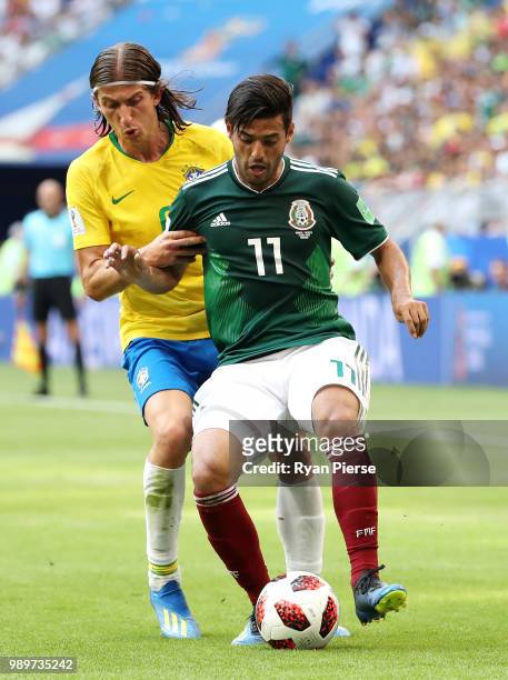 Filipe Luis of Brazil challenges Carlos Vela of Mexico during the 2018 FIFA World Cup Russia Round of 16 match between Brazil and Mexico at Samara...