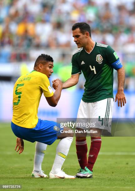 Rafael Marquez of Mexico helps Casemiro of Brazil to his feet during the 2018 FIFA World Cup Russia Round of 16 match between Brazil and Mexico at...