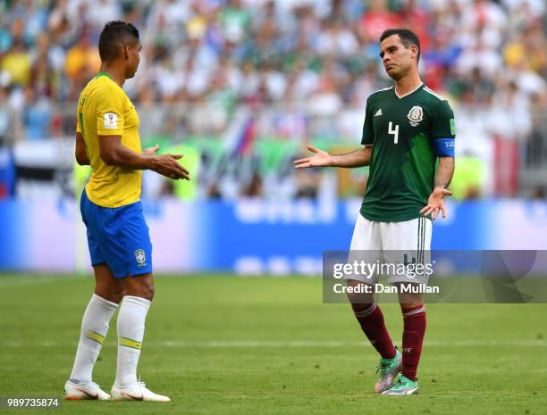 Rafael Marquez of Mexico speaks with Casemiro of Brazil during the 2018 FIFA World Cup Russia Round of 16 match between Brazil and Mexico at Samara...