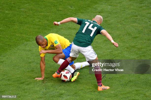 Javier Hernandez of Mexico battles for possession with Miranda of Brazil during the 2018 FIFA World Cup Russia Round of 16 match between Brazil and...