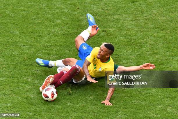 Brazil's forward Gabriel Jesus is tackled by Mexico's defender Carlos Salcedo during the Russia 2018 World Cup round of 16 football match between...