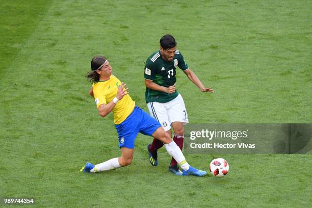 Filipe Luis of Brazil tackles Carlos Vela of Mexico during the 2018 FIFA World Cup Russia Round of 16 match between Brazil and Mexico at Samara Arena...