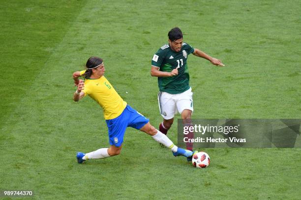 Filipe Luis of Brazil tackles Carlos Vela of Mexico during the 2018 FIFA World Cup Russia Round of 16 match between Brazil and Mexico at Samara Arena...