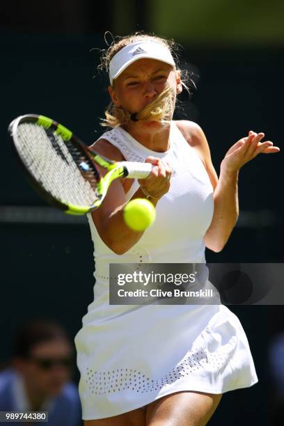 Caroline Wozniacki of Denmark returns a shot against Varvara Lepchenko of the United States during their Ladies' Singles first round match on day one...