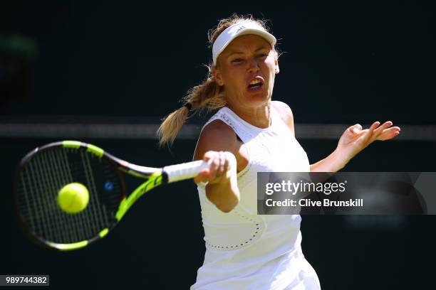 Caroline Wozniacki of Denmark returns a shot against Varvara Lepchenko of the United States during their Ladies' Singles first round match on day one...