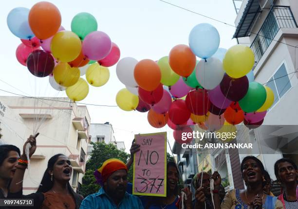 Members of the LGBT community take part in a "Indian Coming out Day" celebration to mark the anniversary of Delhi High Court's verdict amending...