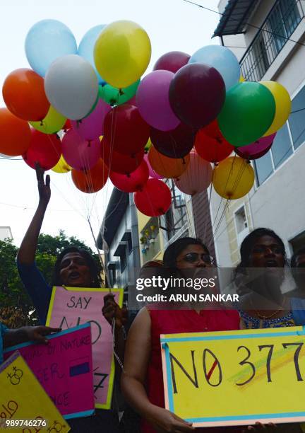 Members of the LGBT community take part in a "Indian Coming out Day" celebration to mark the anniversary of Delhi High Court's verdict amending...