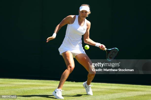 Ekaterina Makarova of Russia returns to Petra Martic of Croatia during their Ladies' Singles first round match on day one of the Wimbledon Lawn...