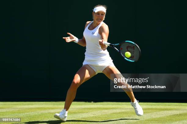 Ekaterina Makarova of Russia returns to Petra Martic of Croatia during their Ladies' Singles first round match on day one of the Wimbledon Lawn...
