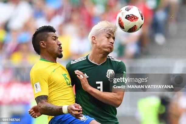 Mexico's defender Carlos Salcedo vies for the ball with Brazil's midfielder Paulinho during the Russia 2018 World Cup round of 16 football match...