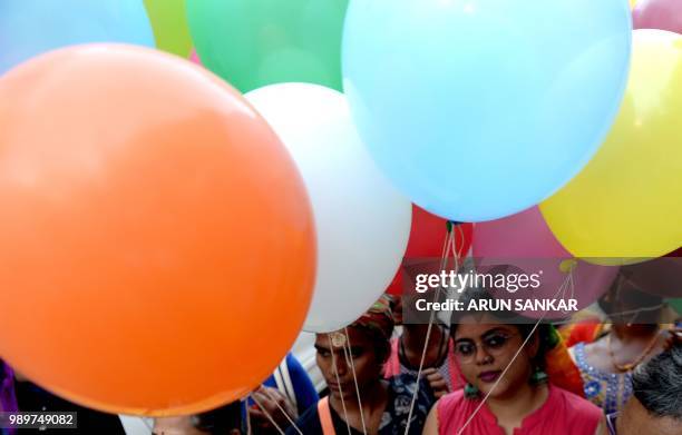 Members of the LGBT community take part in a "Indian Coming out Day" celebration to mark the anniversary of Delhi High Court's verdict amending...