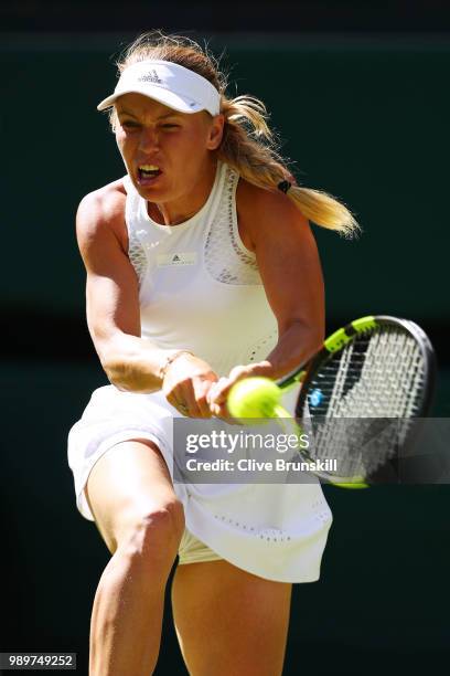 Caroline Wozniacki of Denmark returns a shot against Varvara Lepchenko of the United States during their Ladies' Singles first round match on day one...