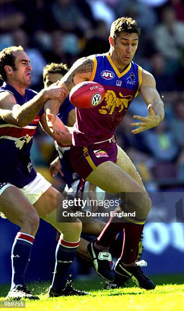 Alastair Lynch of Brisbane in action against Chris Grant of the Bulldogs during the round 18 AFL match between the Brisbane Lions and the Western...