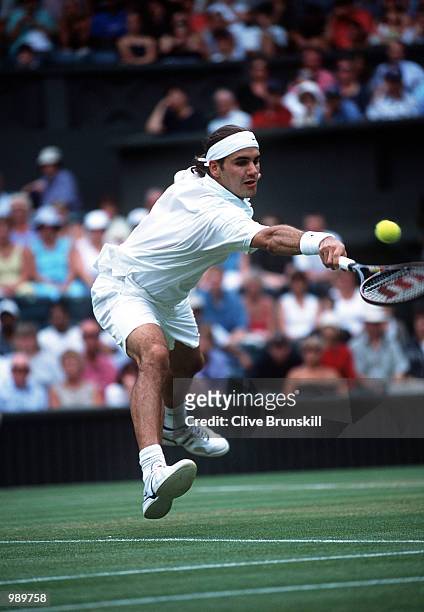 Roger Federer of Switzerland on his way to victory over Pete Sampras of the USA during the men's fourth round of The All England Lawn Tennis...