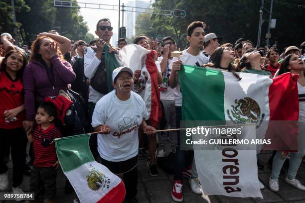 Fans of Mexico watch the World Cup football match between Mexico and Brazil during a public event at the Angel de la Independencia Monument in Mexico...