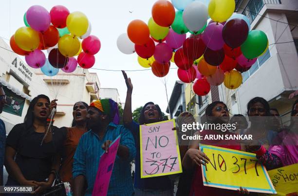 Members of the LGBT community take part in a "Indian Coming out Day" celebration to mark the anniversary of Delhi High Court's verdict amending...