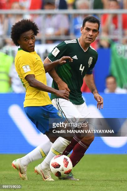 Brazil's forward Willian vies for the ball with Mexico's midfielder Rafael Marquez during the Russia 2018 World Cup round of 16 football match...