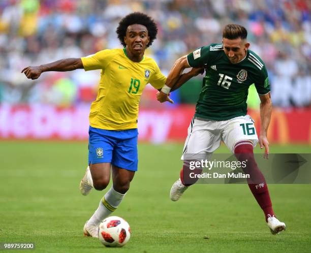 Willian of Brazil is challenged by Hector Herrera of Mexico during the 2018 FIFA World Cup Russia Round of 16 match between Brazil and Mexico at...