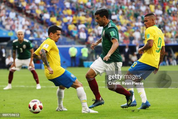 Carlos Vela of Mexico challenge for the ball with bra22a and Gabriel Jesus of Brazil during the 2018 FIFA World Cup Russia Round of 16 match between...