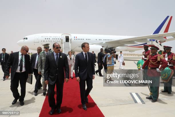 Mauritania President Mohamed Ould Abdel Aziz welcomes French President Emmanuel Macron upon his arrival at Nouakchott on July 2, 2018. - Macron,...