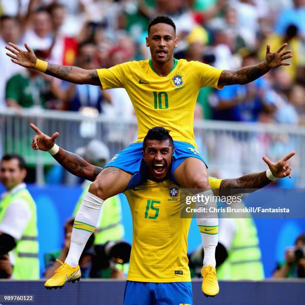 Neymar of Brazil celebrates with teammate Paulinho after scoring his sides first goal during the 2018 FIFA World Cup Russia Round of 16 match between...