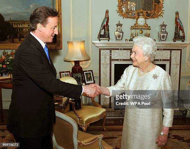Britain's Queen Elizabeth II greets David Cameron at Buckingham Palace in an audience to invite him to be the next Prime Minister, on May 11, 2010 in...