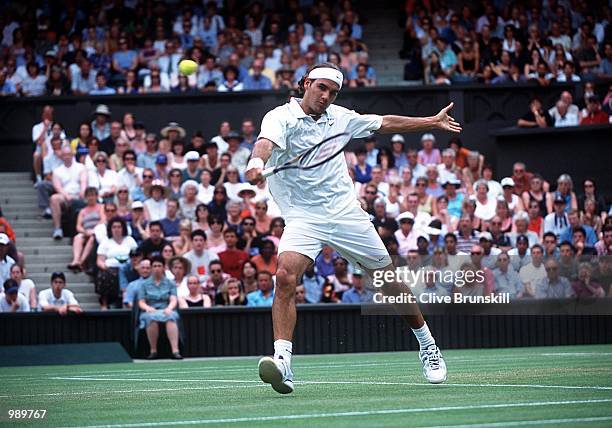 Roger Federer of Switzerland plays a backhand on his way to victory over Pete Sampras of the USA during the men's fourth round of The All England...