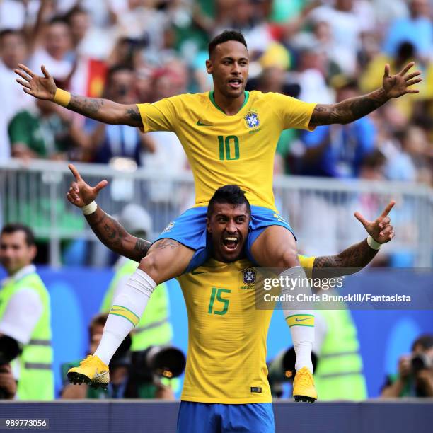 Neymar of Brazil celebrates with teammate Paulinho after scoring his sides first goal during the 2018 FIFA World Cup Russia Round of 16 match between...