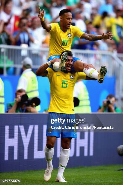 Neymar of Brazil celebrates with teammate Paulinho after scoring his sides first goal during the 2018 FIFA World Cup Russia Round of 16 match between...